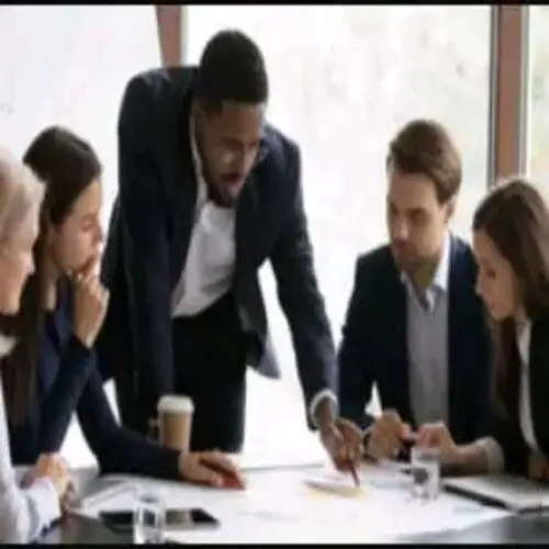 A group of people sitting around a table.